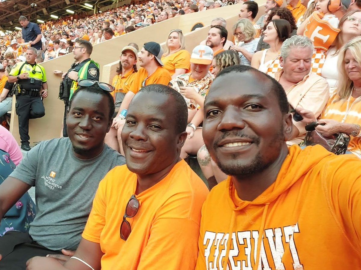 David Tendo, Daniel Kizza, Moses Olum pictured at a UT football game.