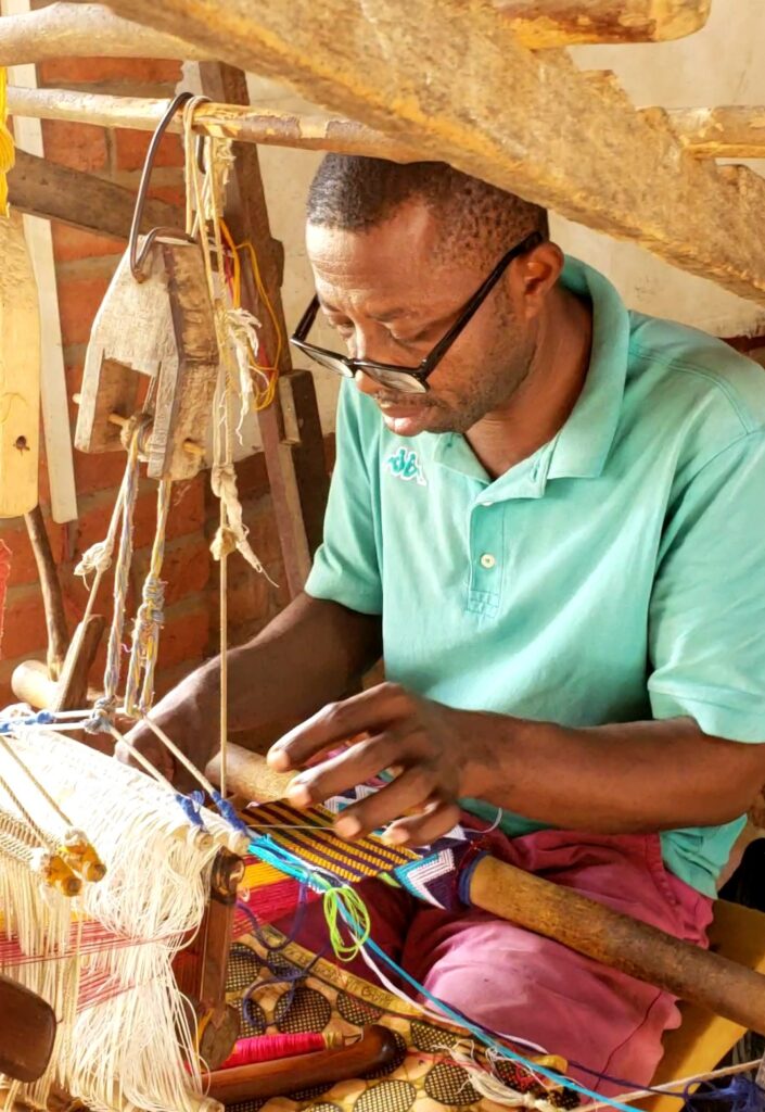 In the Asante Region of Ghana, Kente weaving on traditional looms, a 1,000 year old Ghanaian tradition. Photo taken by A. Muhammad.