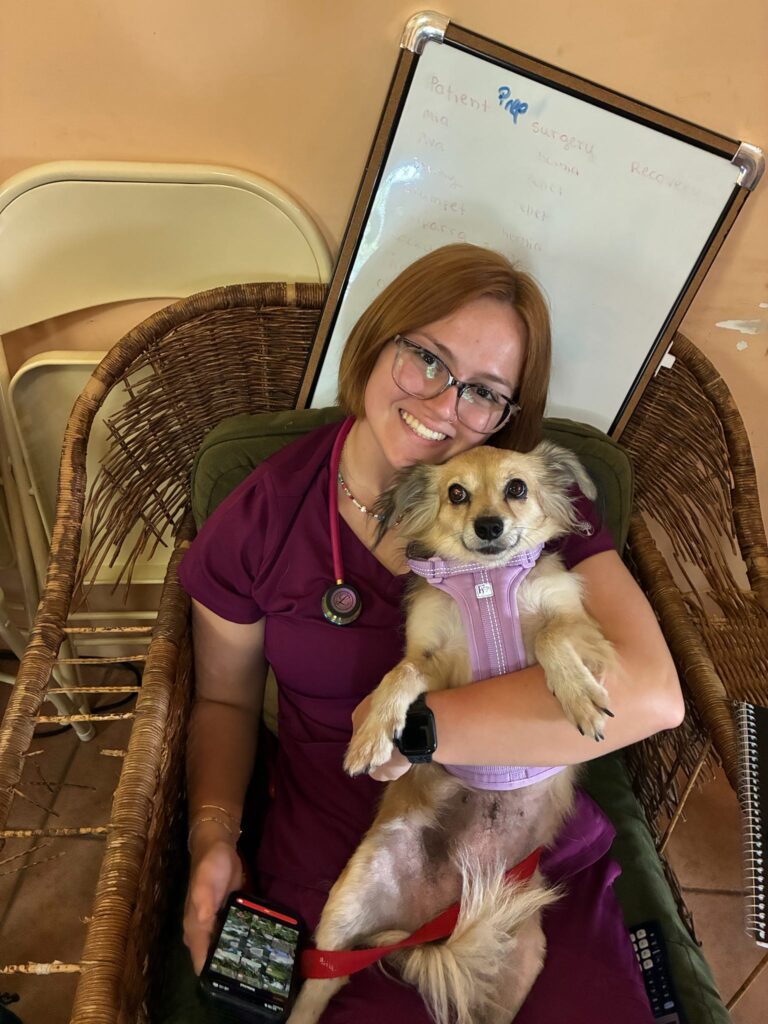 A student holding a dog.