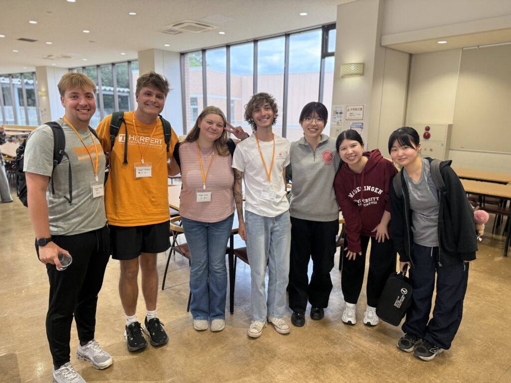 University of Tennessee students smiling with students from a university in Japan.