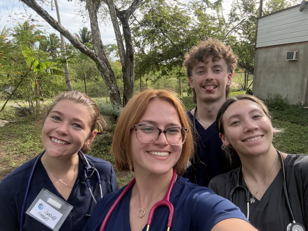 Four students smiling for a photo.