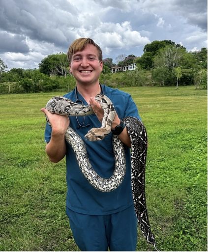 A student holding a snake.