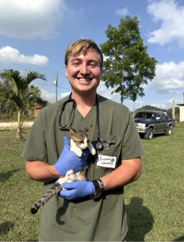 A student holding a cat.