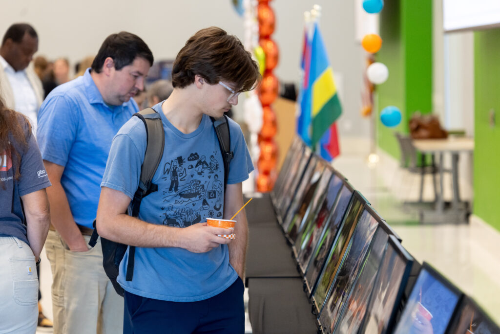 A student views the photo contest submissions at the Smith Center International Showcase at the ANR Building on September 10, 2026. Photo by Raffe Lazarian / UTIA