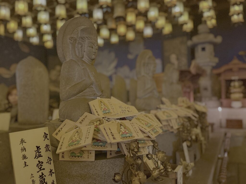 Cement statues covered with handwritten notes at the bottom of the statues.