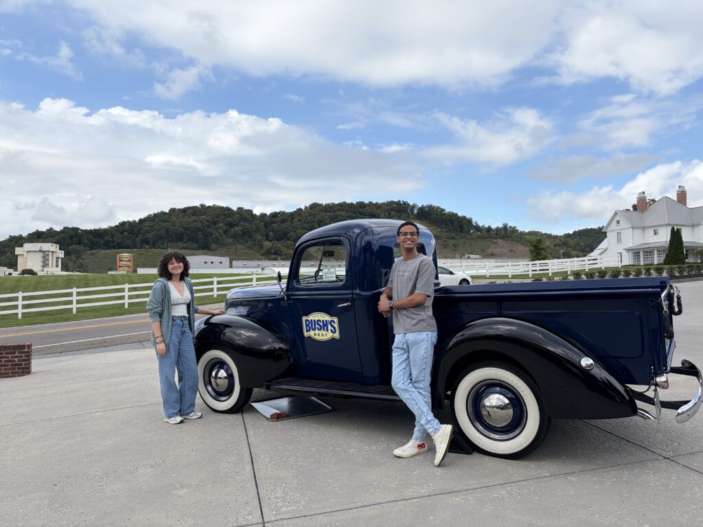 Two students standing in front of a blue truck.